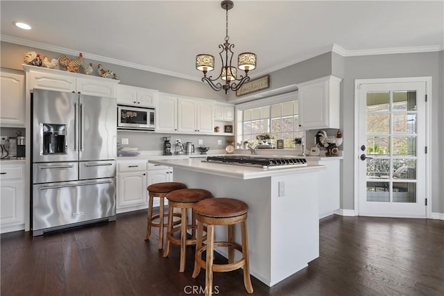 kitchen featuring a center island, white cabinetry, and stainless steel appliances