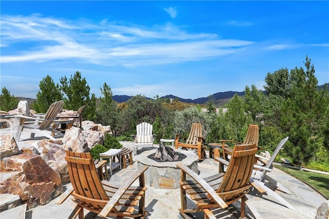 view of patio / terrace featuring a fire pit and a mountain view