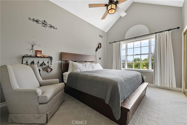 bedroom featuring ceiling fan, light carpet, and high vaulted ceiling