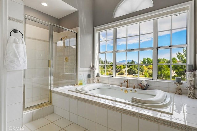 bathroom featuring tile patterned flooring and separate shower and tub