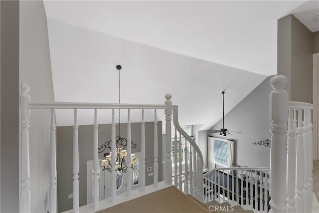 staircase featuring ceiling fan, carpet floors, and high vaulted ceiling