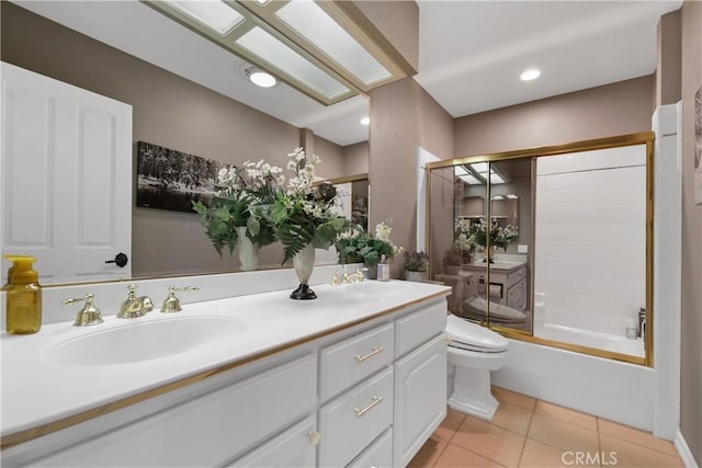 full bathroom with tile patterned flooring, vanity, toilet, and bath / shower combo with glass door