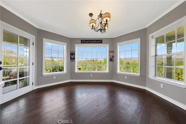 unfurnished dining area featuring dark hardwood / wood-style flooring, a chandelier, and ornamental molding