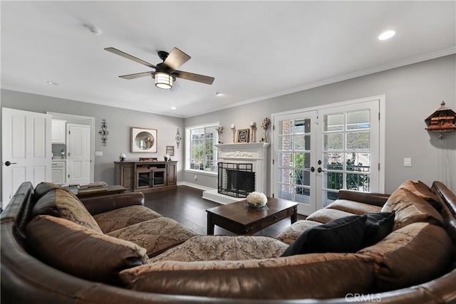 living room with ceiling fan, french doors, dark hardwood / wood-style floors, and ornamental molding