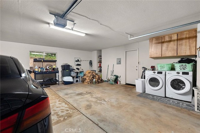 garage featuring separate washer and dryer and a garage door opener