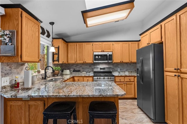 kitchen with kitchen peninsula, appliances with stainless steel finishes, lofted ceiling, and sink