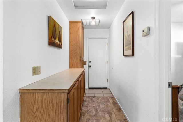 doorway with light tile patterned floors