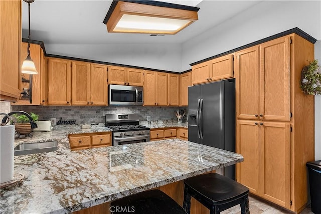 kitchen featuring hanging light fixtures, backsplash, kitchen peninsula, lofted ceiling, and appliances with stainless steel finishes