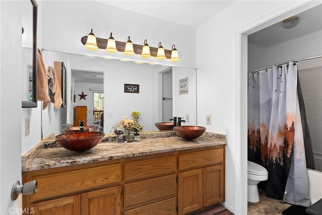 full bathroom with tile patterned floors, shower / tub combo with curtain, vanity, and toilet