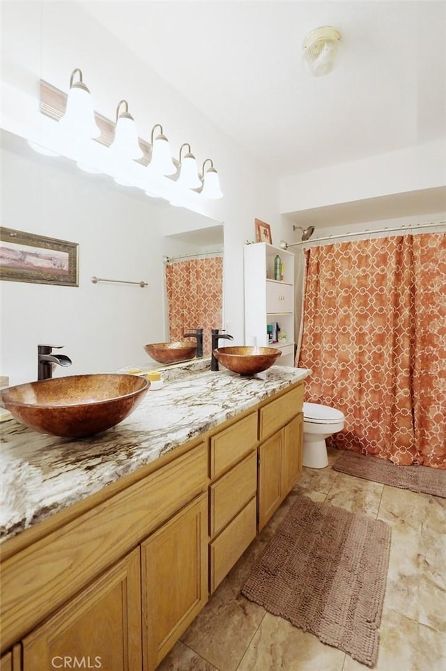 bathroom featuring vanity, toilet, and walk in shower