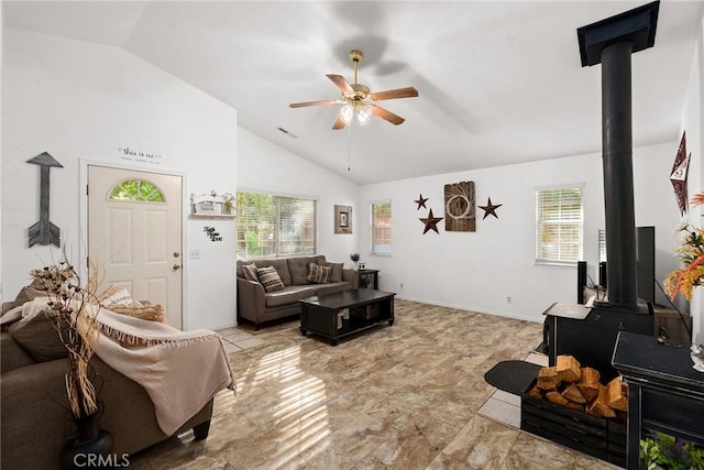 living room with high vaulted ceiling, a wood stove, and ceiling fan