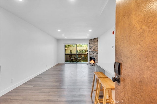 unfurnished living room with wood-type flooring and a fireplace