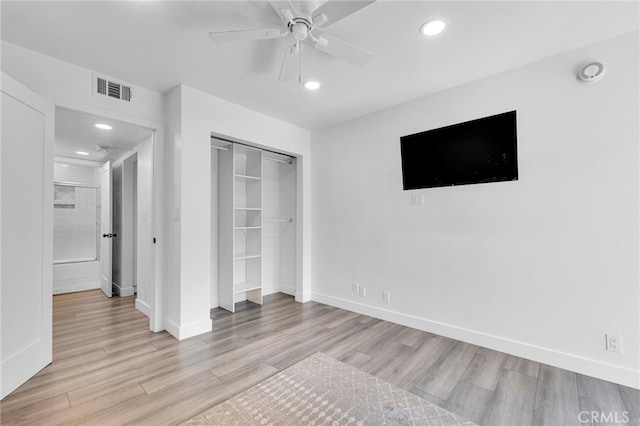 unfurnished bedroom with a closet, light hardwood / wood-style floors, and ceiling fan