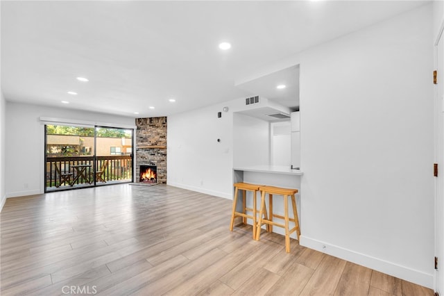 living room with a fireplace and light hardwood / wood-style flooring