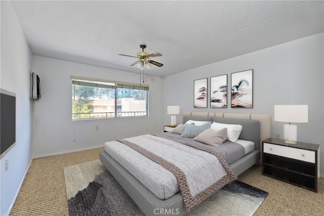 bedroom with light carpet and ceiling fan