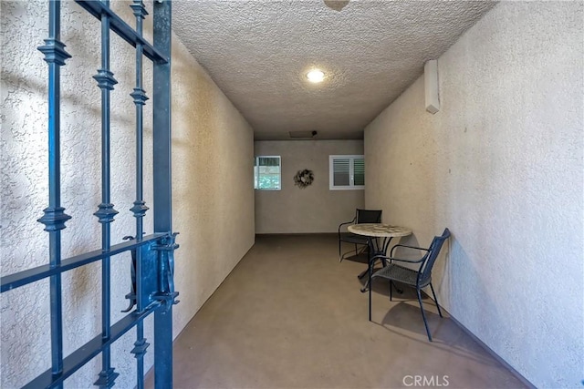 hallway featuring concrete floors and a textured ceiling