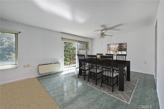 tiled dining area with ceiling fan and radiator heating unit