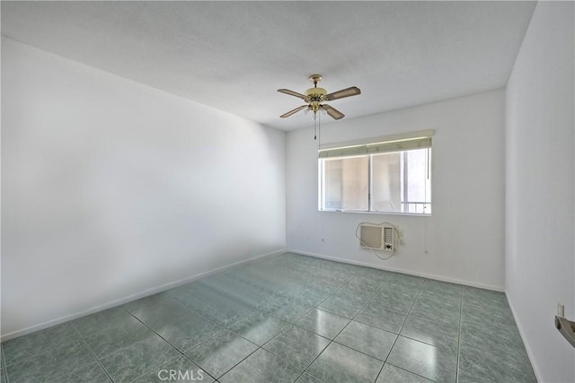 tiled spare room with an AC wall unit and ceiling fan