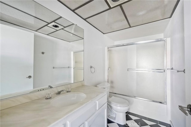 full bathroom featuring combined bath / shower with glass door, vanity, and toilet