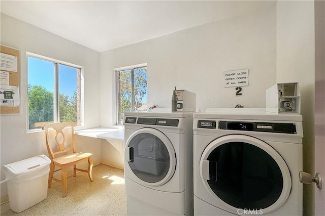 clothes washing area featuring separate washer and dryer