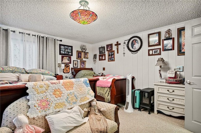 carpeted bedroom with a textured ceiling and wooden walls