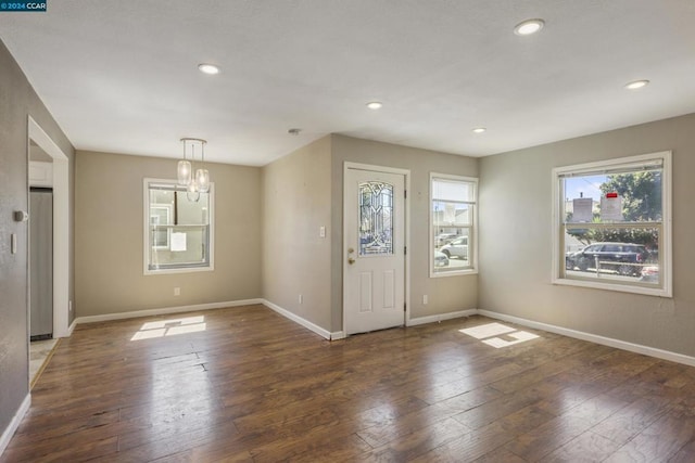 entrance foyer with a chandelier and dark wood-type flooring