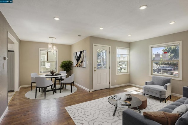 living room with hardwood / wood-style floors and a notable chandelier