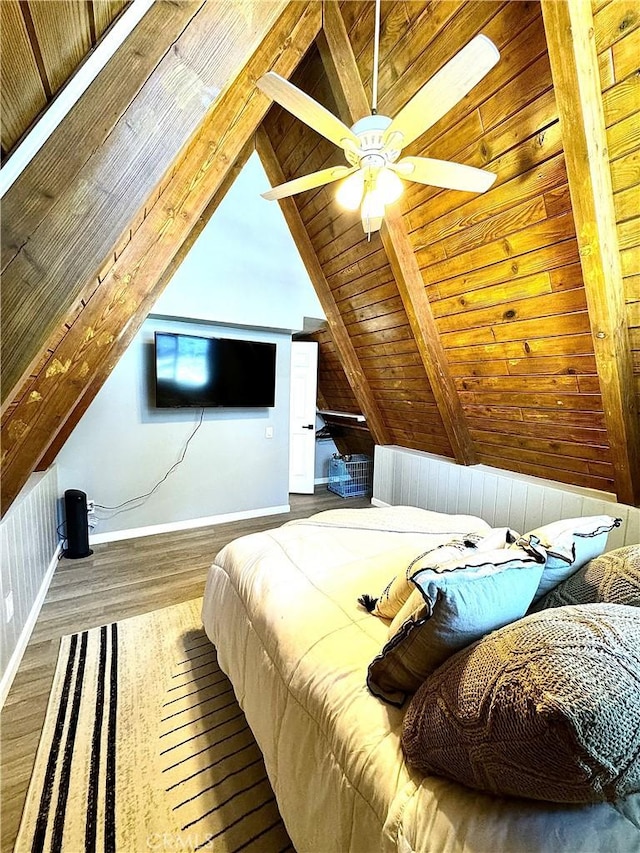 bedroom with hardwood / wood-style flooring, lofted ceiling with beams, ceiling fan, and wooden ceiling