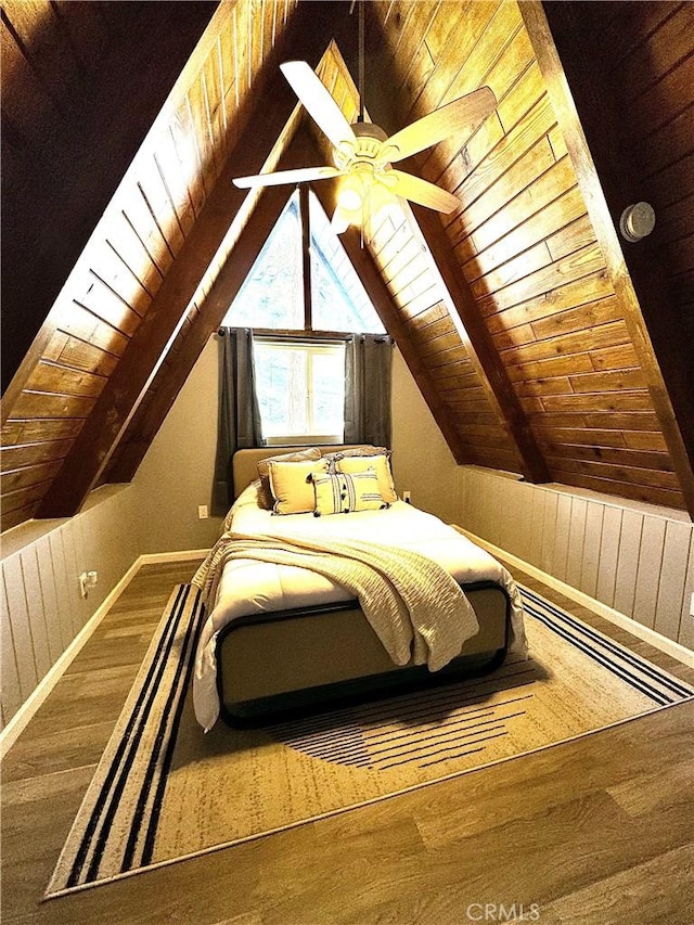 bedroom with lofted ceiling with beams, ceiling fan, hardwood / wood-style floors, and wooden ceiling