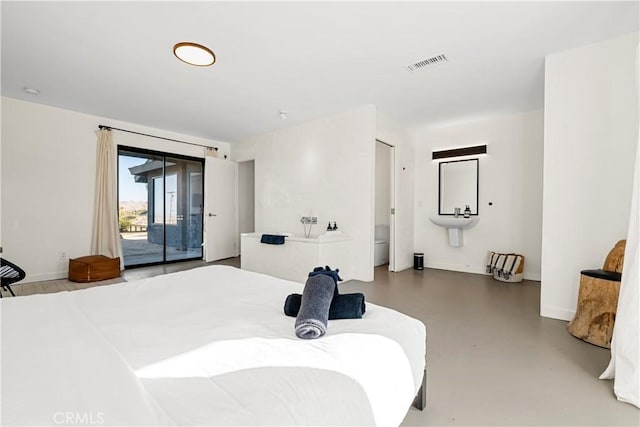 bedroom featuring access to exterior and concrete flooring