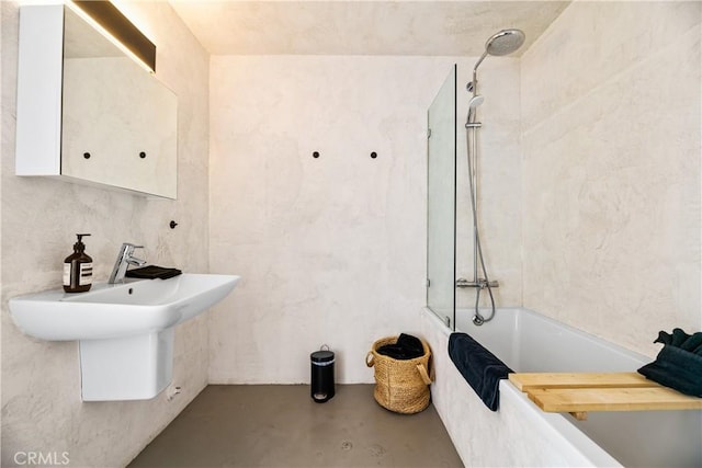 bathroom featuring shower / bathing tub combination and concrete flooring