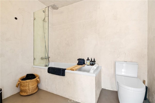 bathroom featuring concrete floors and toilet