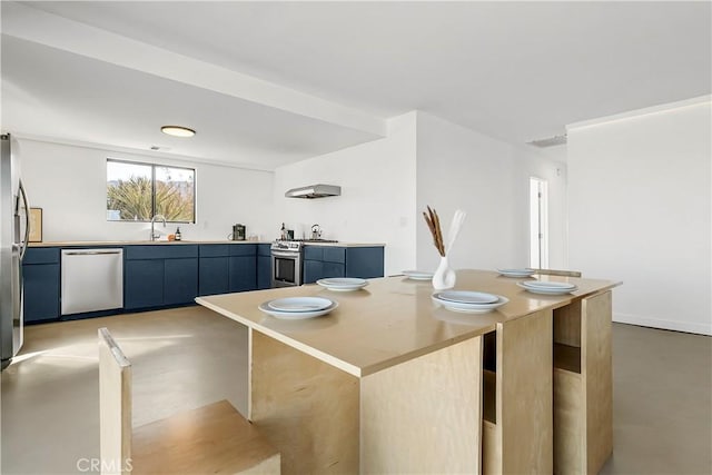 kitchen with blue cabinetry, stainless steel appliances, extractor fan, and sink