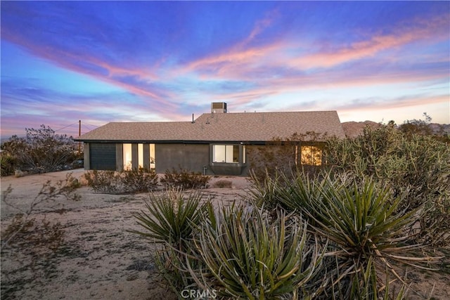 property exterior at dusk featuring a garage