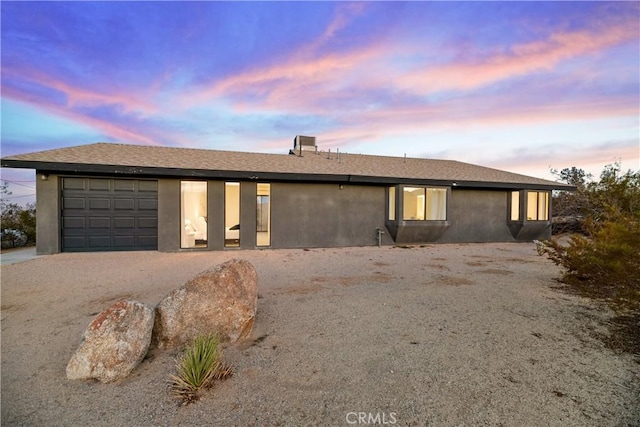 ranch-style home featuring a garage