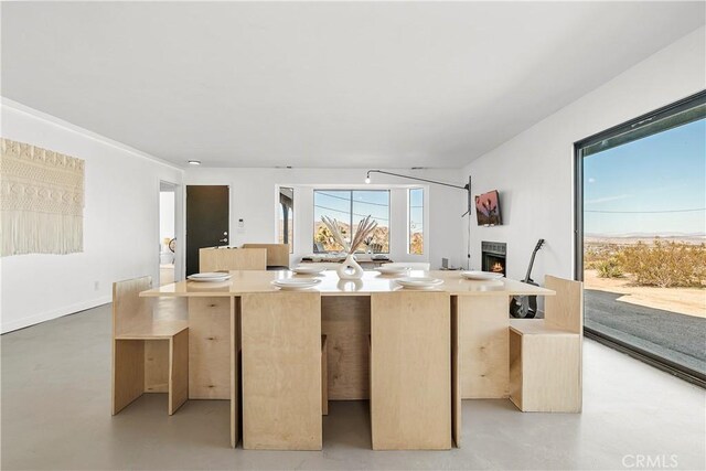 kitchen featuring light brown cabinets and an island with sink