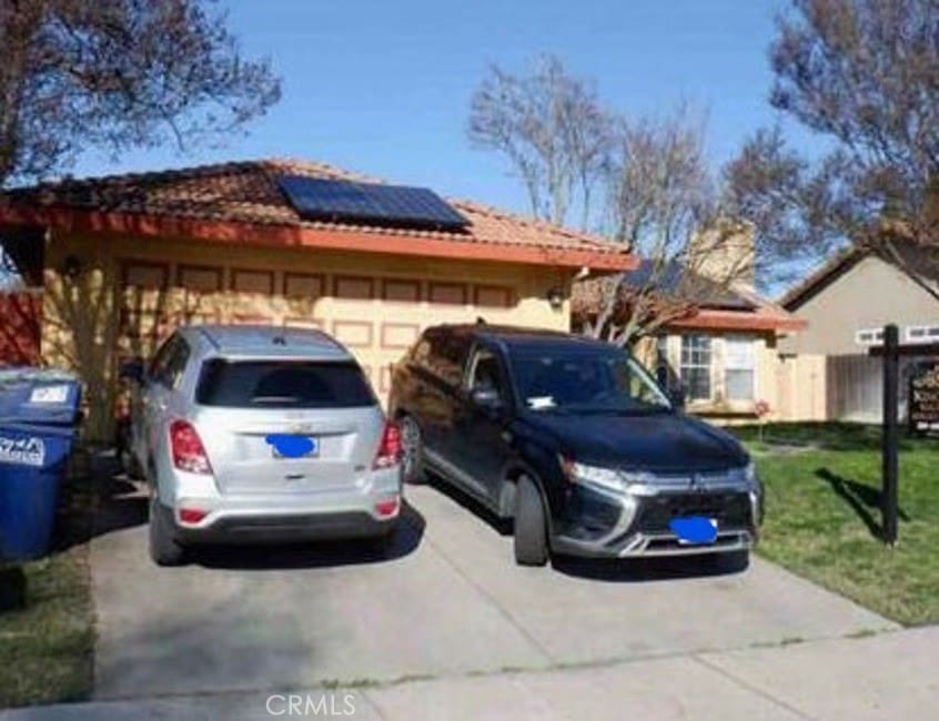 exterior space featuring solar panels and a front yard