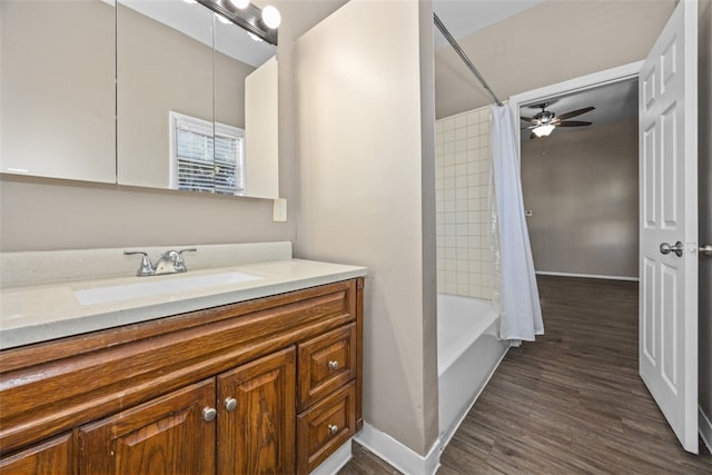 bathroom featuring shower / tub combo with curtain, ceiling fan, wood-type flooring, and vanity