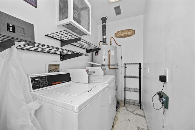 clothes washing area with washing machine and clothes dryer and water heater