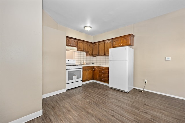 kitchen featuring decorative backsplash, white appliances, sink, and dark wood-type flooring