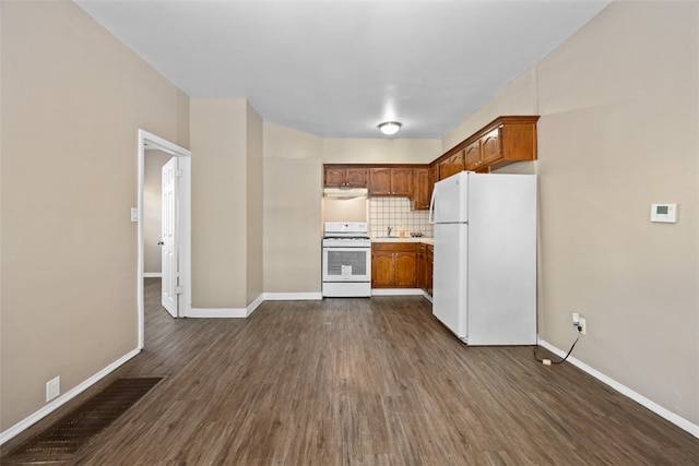 kitchen featuring white appliances, dark hardwood / wood-style floors, and tasteful backsplash