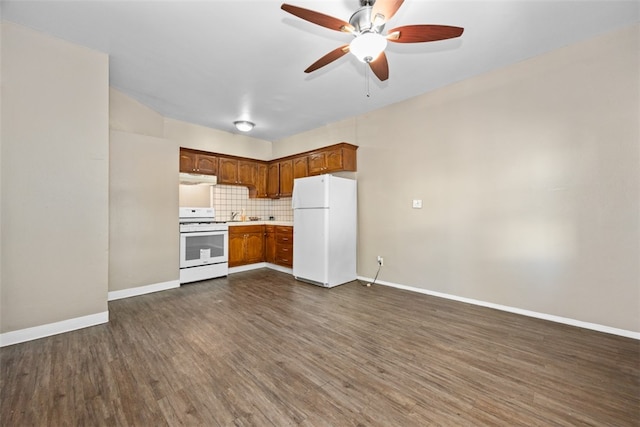 kitchen featuring ceiling fan, dark wood-type flooring, white appliances, and tasteful backsplash