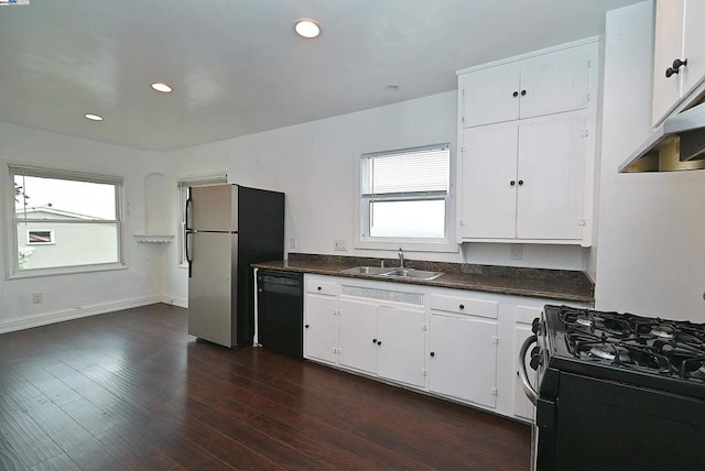 kitchen with sink, white cabinets, black appliances, and dark hardwood / wood-style flooring