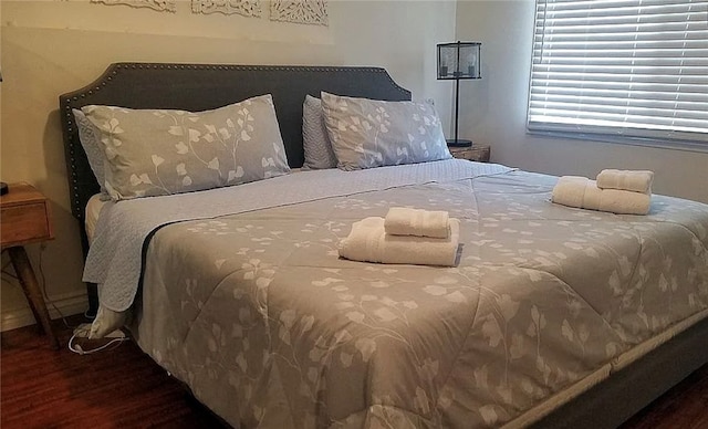 bedroom featuring dark wood-type flooring