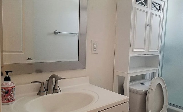 bathroom featuring vanity and toilet