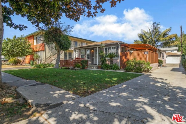 view of front of home featuring a garage and a front lawn