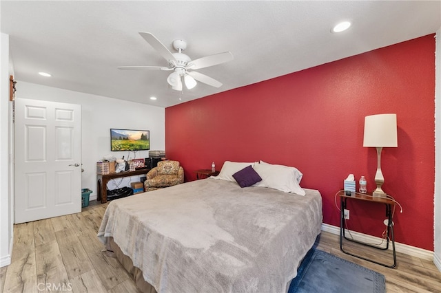 bedroom with ceiling fan and light hardwood / wood-style floors