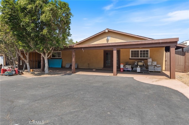 view of front of property featuring a carport