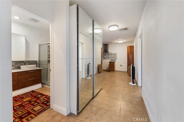 bathroom with decorative backsplash, vanity, tile patterned floors, and a shower with shower door