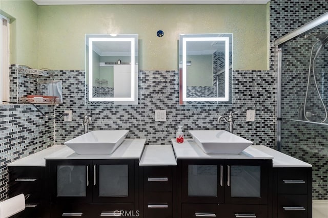 bathroom featuring ornamental molding, decorative backsplash, a shower with door, and vanity